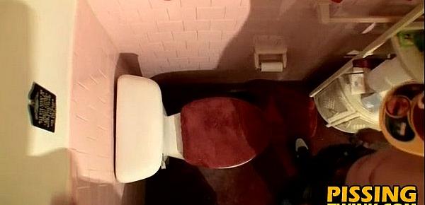  Cute twink flops out his cock and pisses in the toilet bowl
